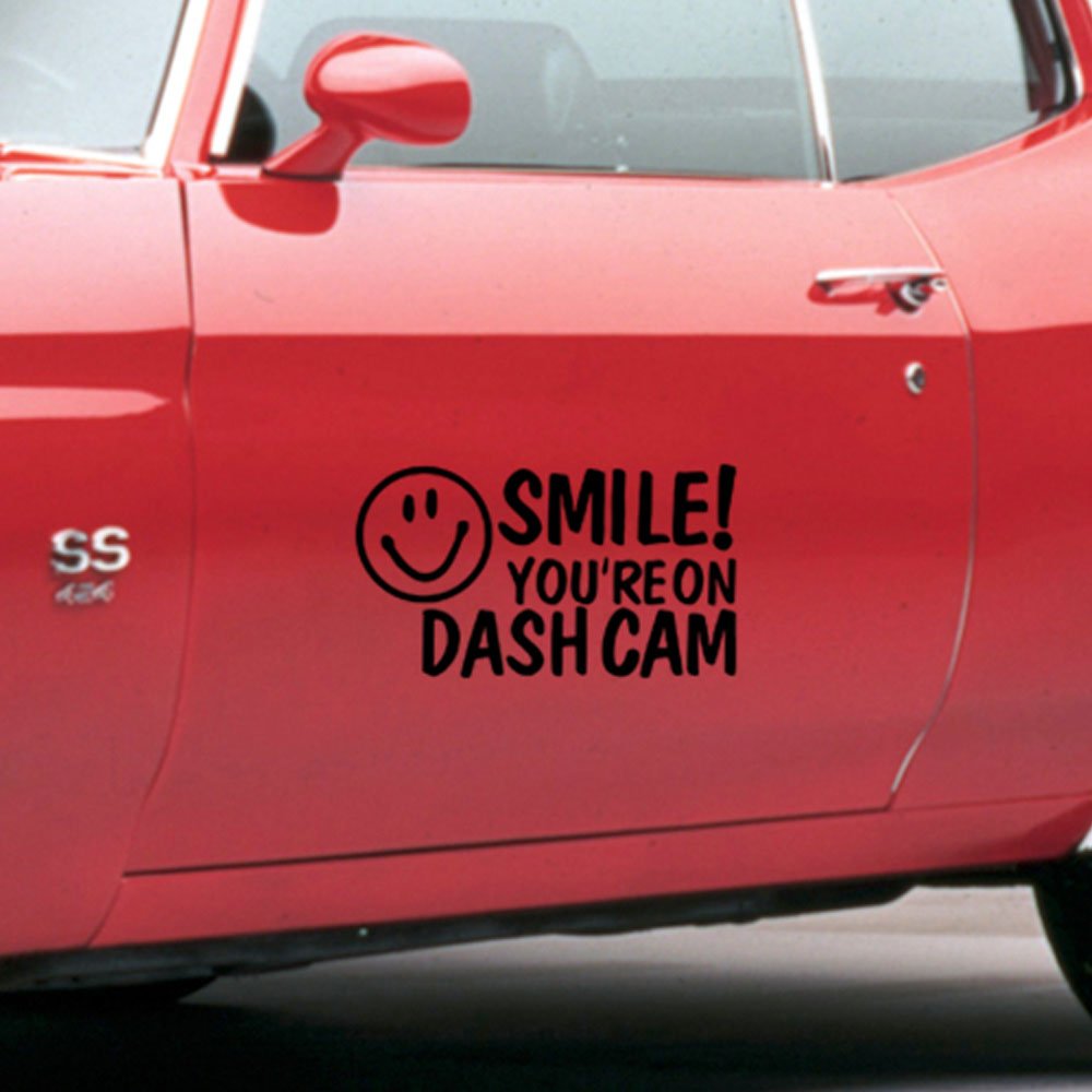 A smiley face decal and text 'SMILE! YOU'RE ON DASH CAM' on a blurred background